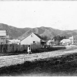 Road next to R. Elliott City Bakery and house looking toward Settlers Hotel